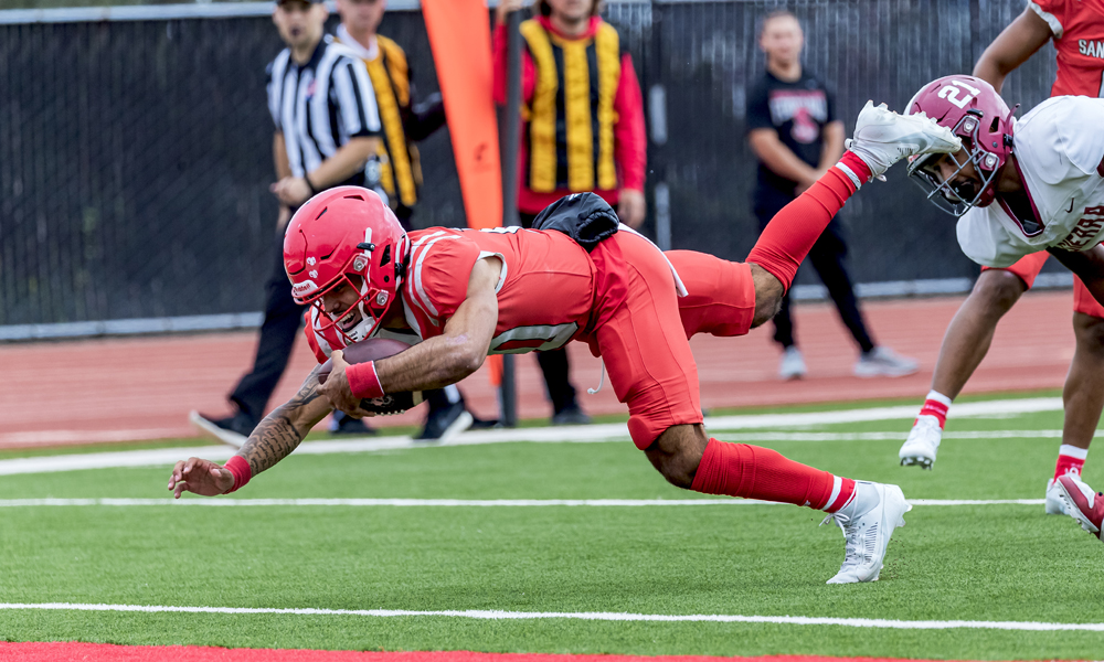 Quarterback Dorian Hale dives for one of his two rushing touchdowns. He totaled 6 TDs on the day in the win over Sierra. (Photo by Eric Sun)